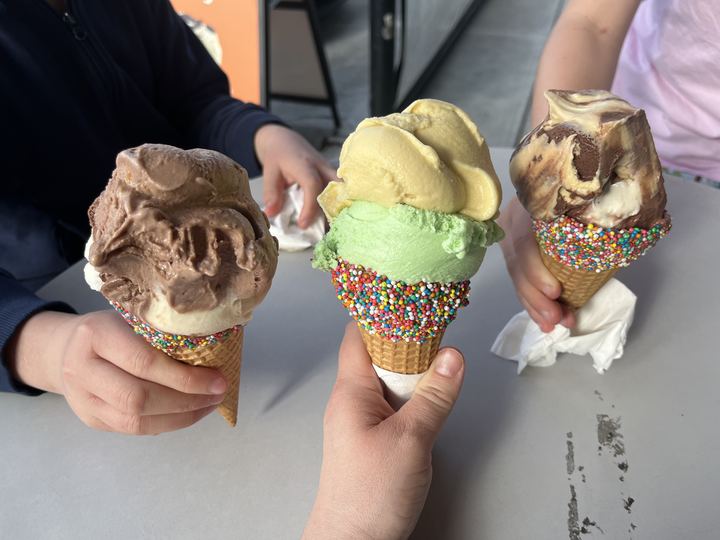 Several ice cream cones with colourful scoops