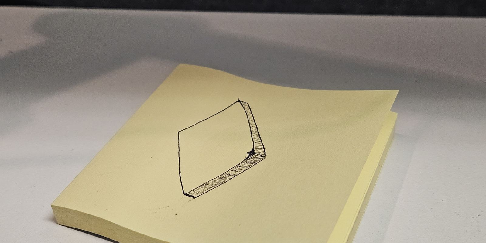A yellow sticky note with a drawing of a sticky note on it