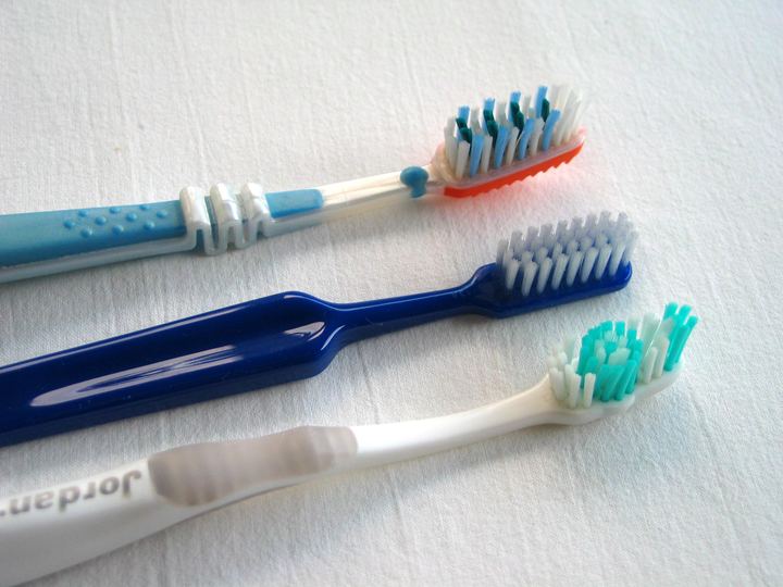 Three colourful toothbrushes