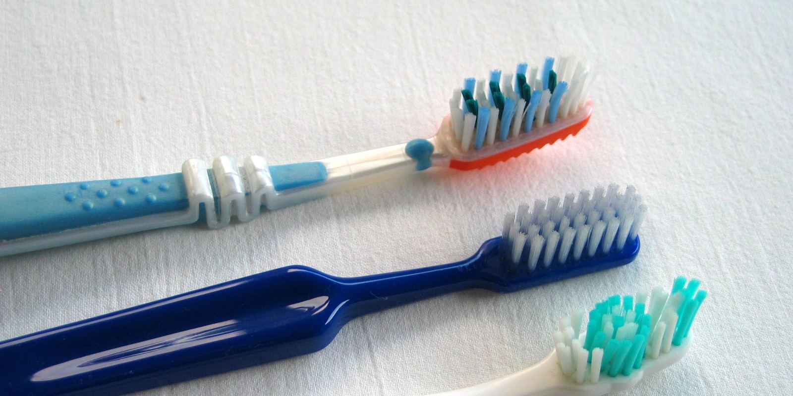 Three colourful toothbrushes