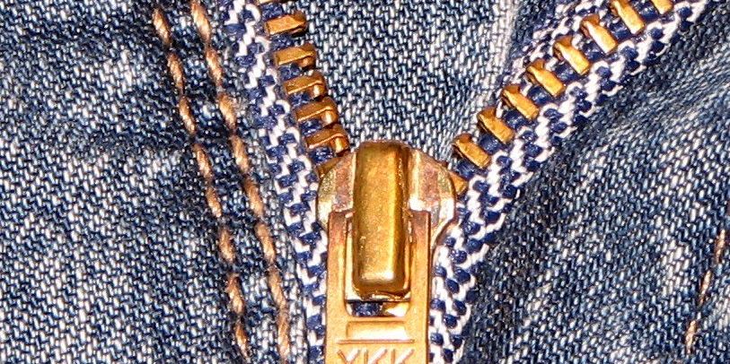 Close-up of a metal zipper on a pair of jeans